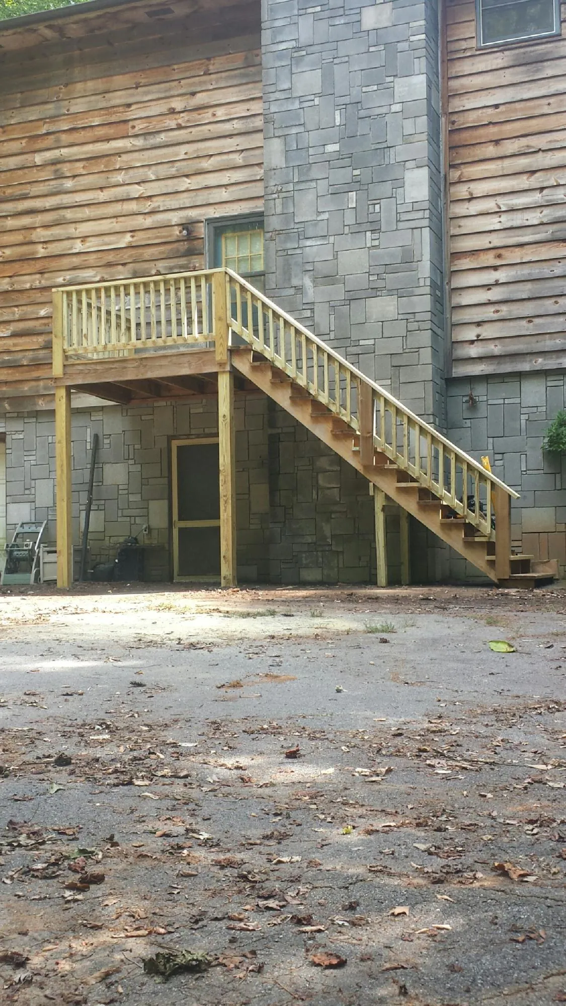 New pressure treated deck and stair landing on a log home in Eufaula