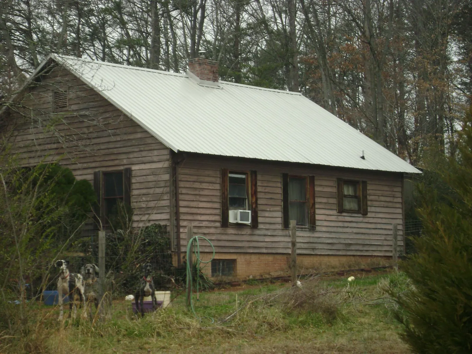 White metal roof on an old wood sided farmhouse, from a Metal Roof Installation job in Eufaula
